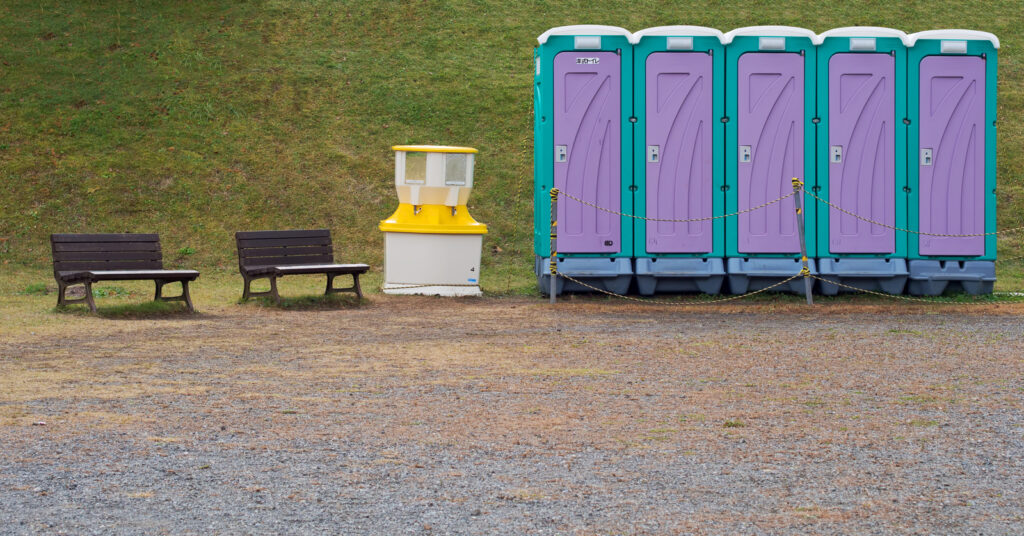 five portable violet toilets