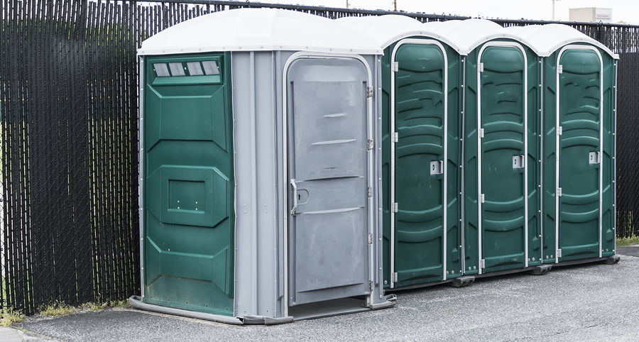 four portable green toilets