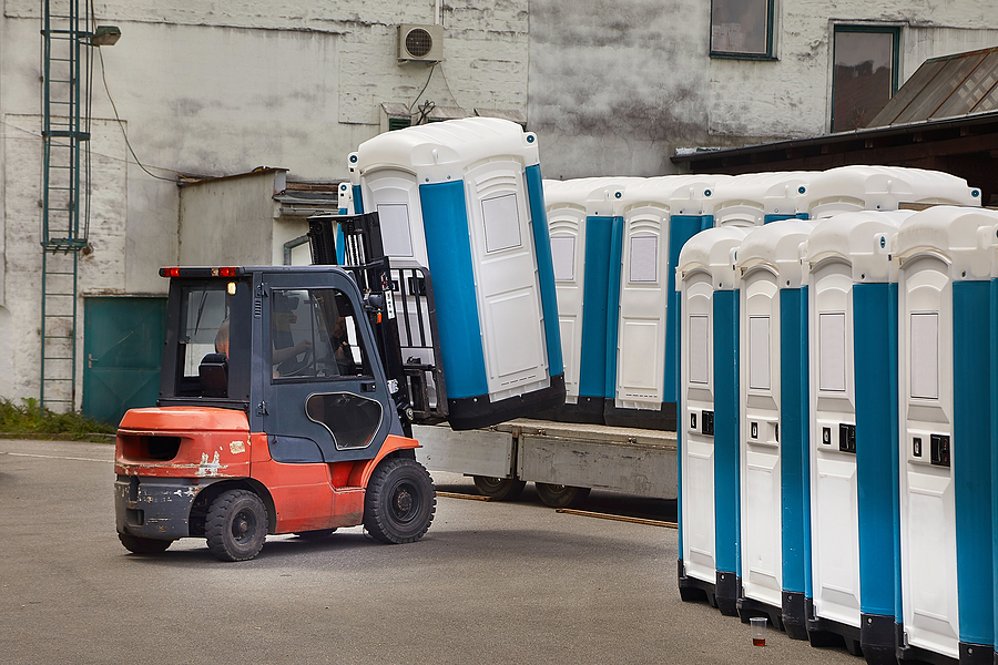 small picker mobile is picking up the portable toilets